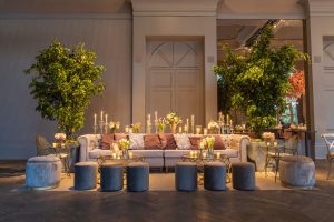 Stylish lounge setup with plush sofa, candles, and lush greenery indoors. — Benefits of using Software in Interior Designing