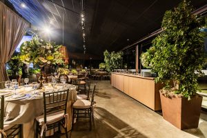 Chic indoor dining area with floral arrangements, elegant table settings, and warm lighting. — How Decorative Candle lights C