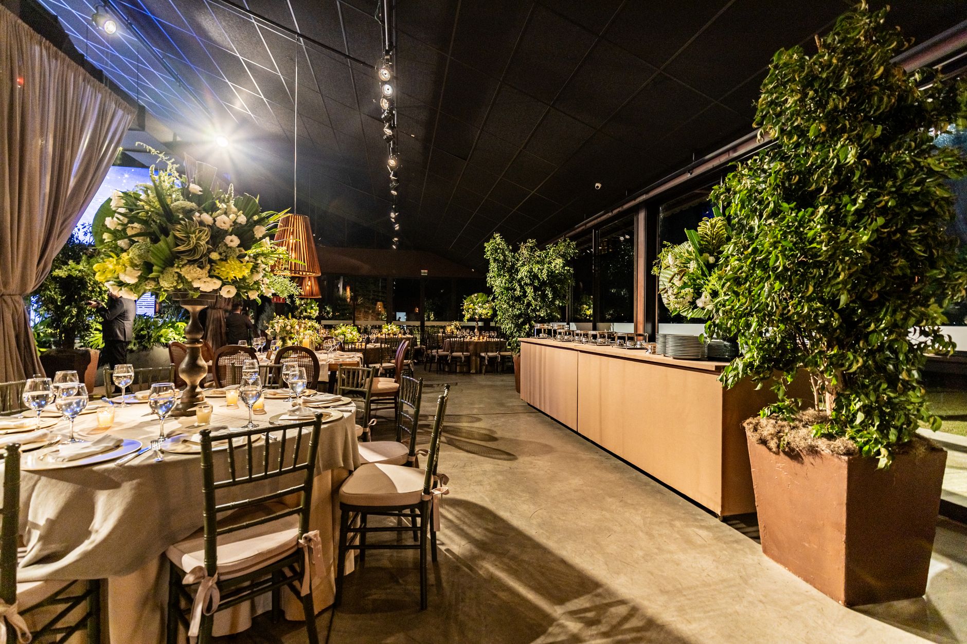 Chic indoor dining area with floral arrangements, elegant table settings, and warm lighting. — How Decorative Candle lights C