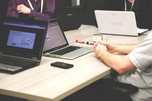Laptops, meeting, businessmen — How Forex Trading Supports Investors With Market Analysis and Trade Execution