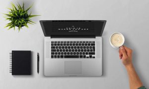 Laptop, coffee, arm — How Often Should I Clean My Restaurant Kitchen Hood?