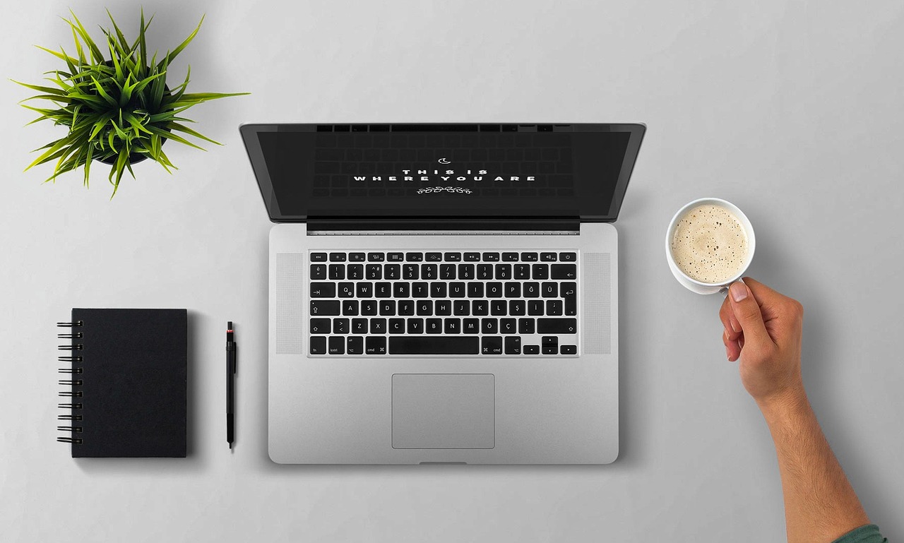 Laptop, coffee, arm — How Often Should I Clean My Restaurant Kitchen Hood?