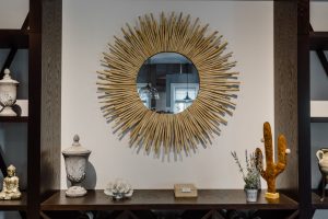 Contemporary living room featuring a unique sunburst mirror and chic decor accents. — Inflatable Adornments For Holidays - Ha