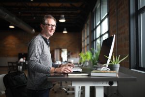 Office desk, man, business — Tips On How To Be Instagram Famous With Famoid