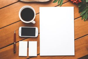 Coffee, phone, paper — Where Did You Get Your Cheap Dark Vinyl Peel and Stick Flooring?